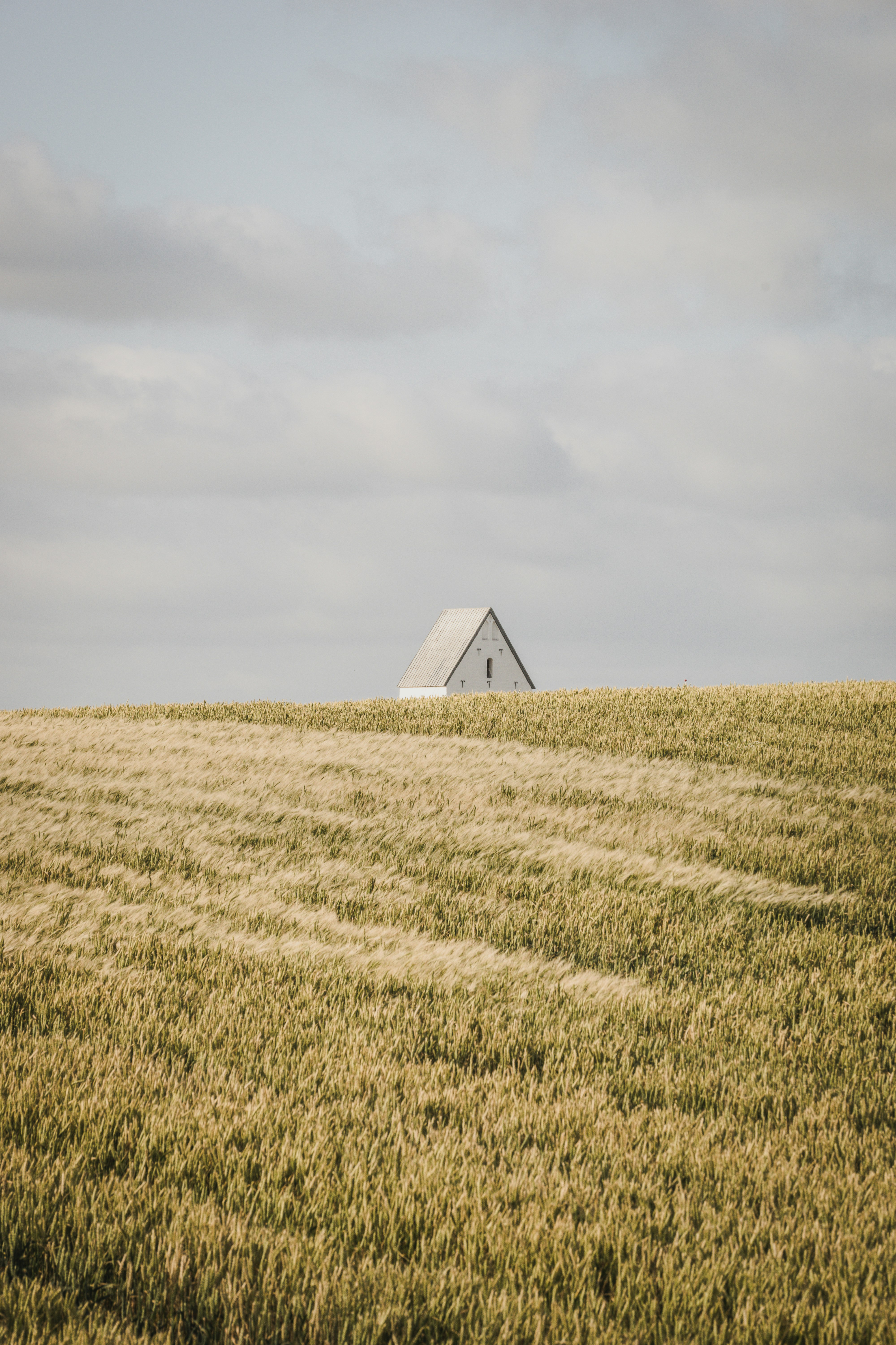 white pyramid on brown field under white sky during daytime